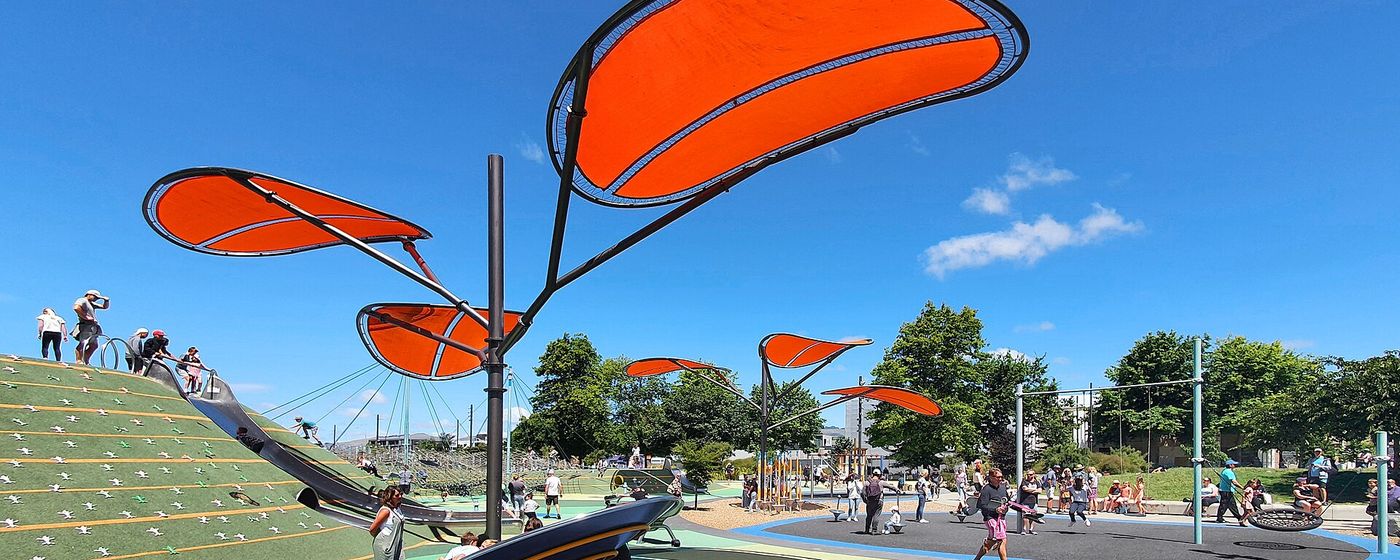 A colourful playground with orange shade sails