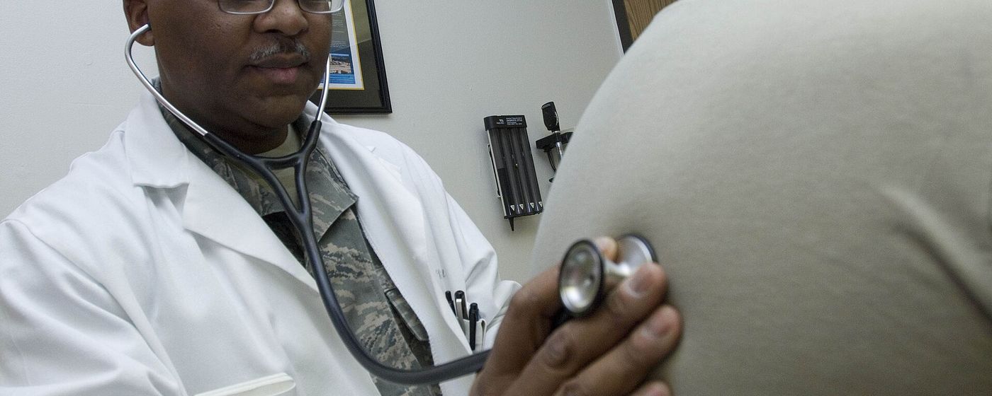A doctor examining a patient with a stethoscope