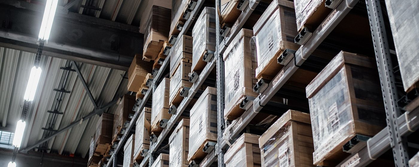 Rows of labelled, tracked pallets stacked on warehouse racking