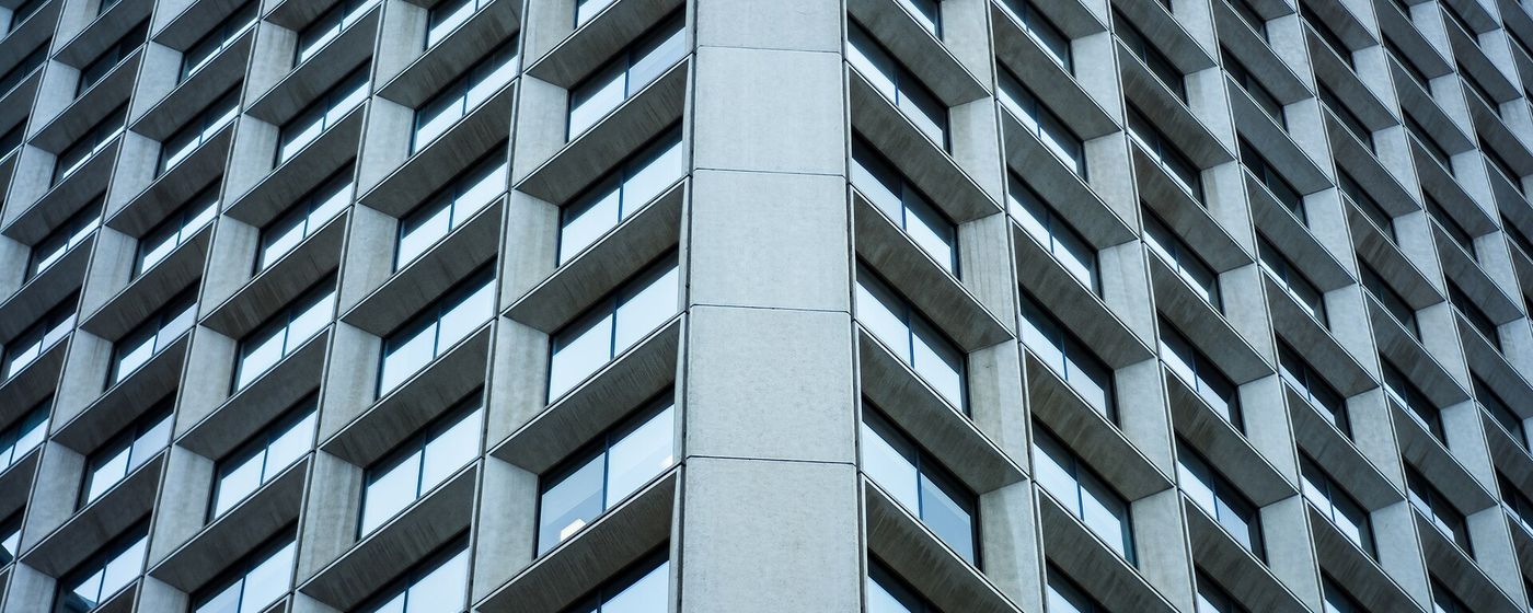 The glass facade of an office tower