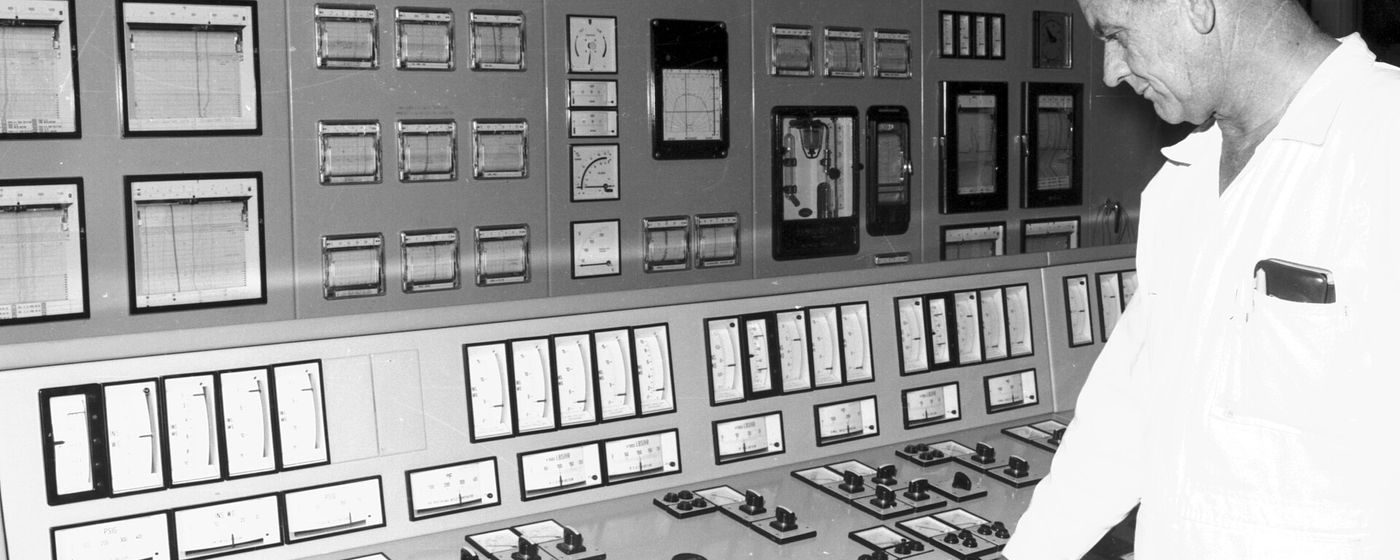 A control room operator monitoring a wall of instrument panels at Callide Power Station