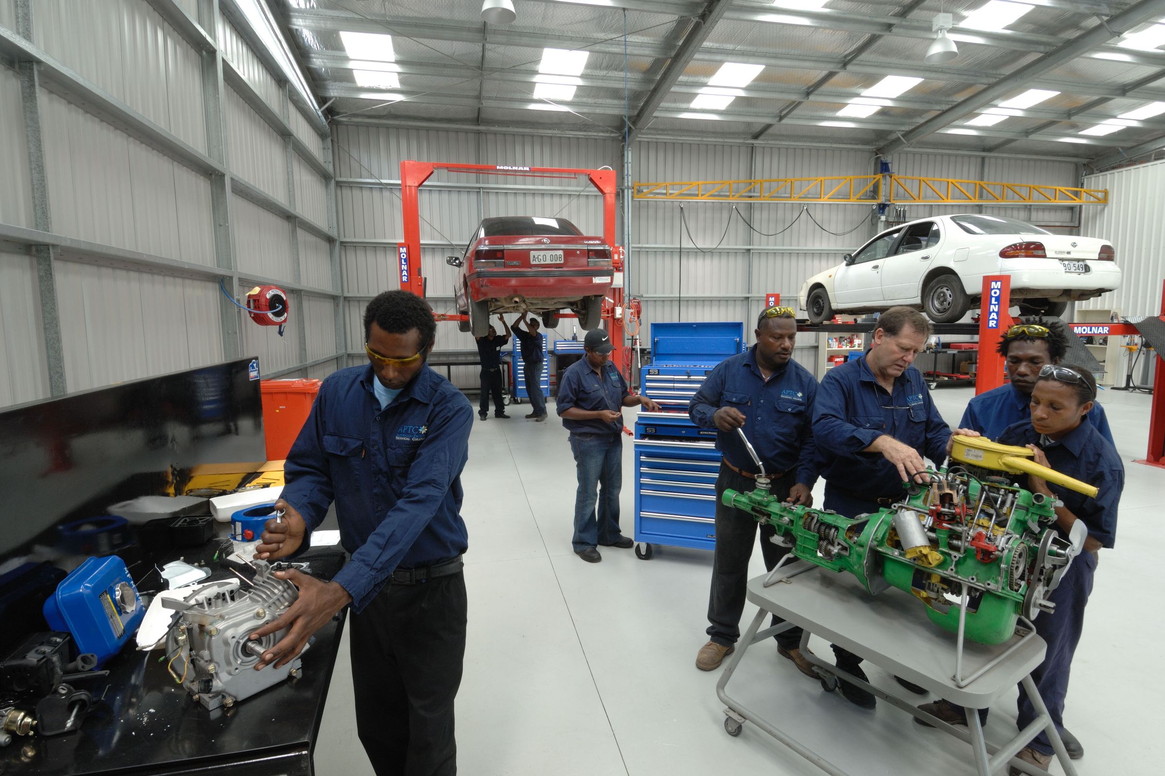 Trainees in a mechanics workshop