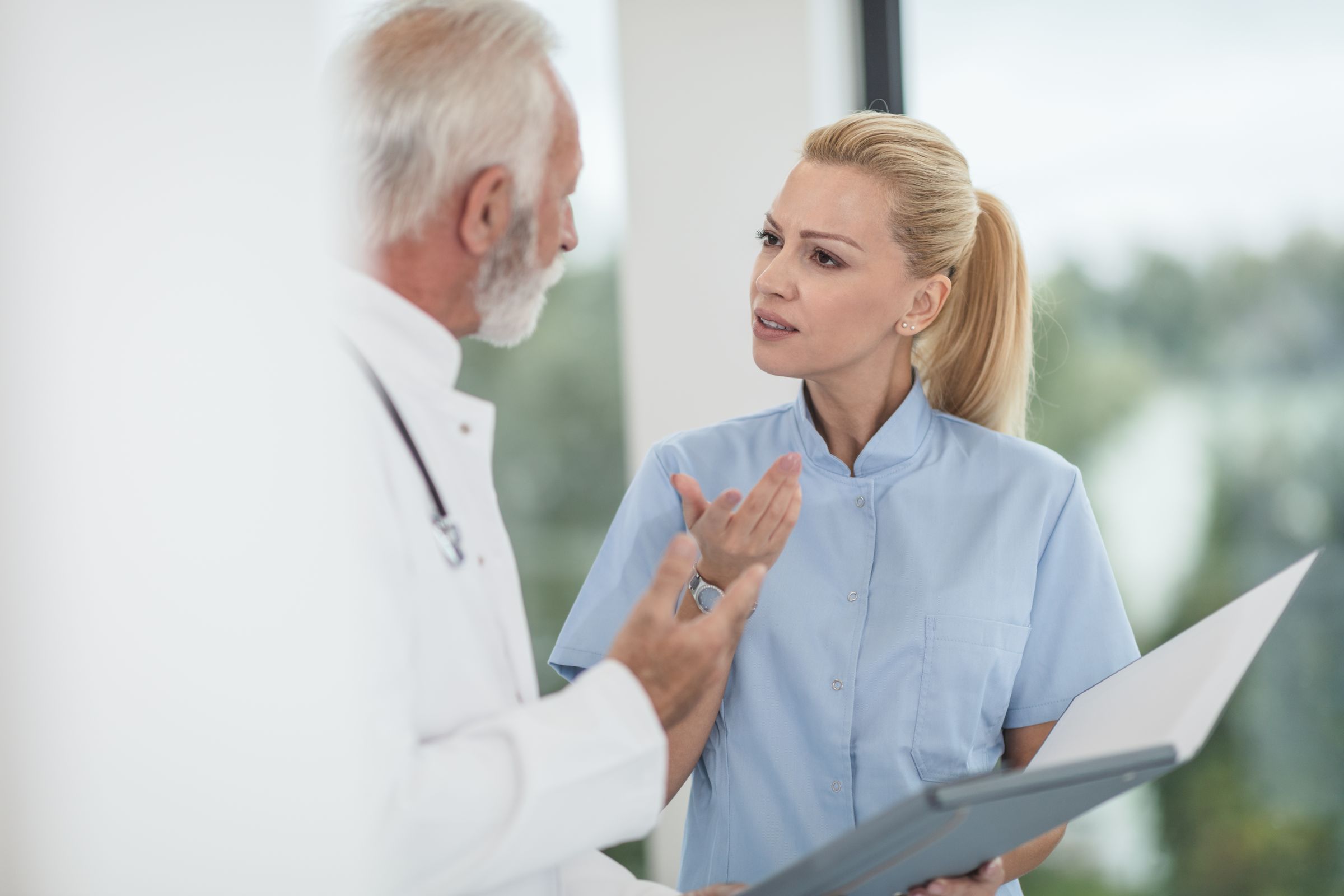 A doctor and a nurse reviewing a chart