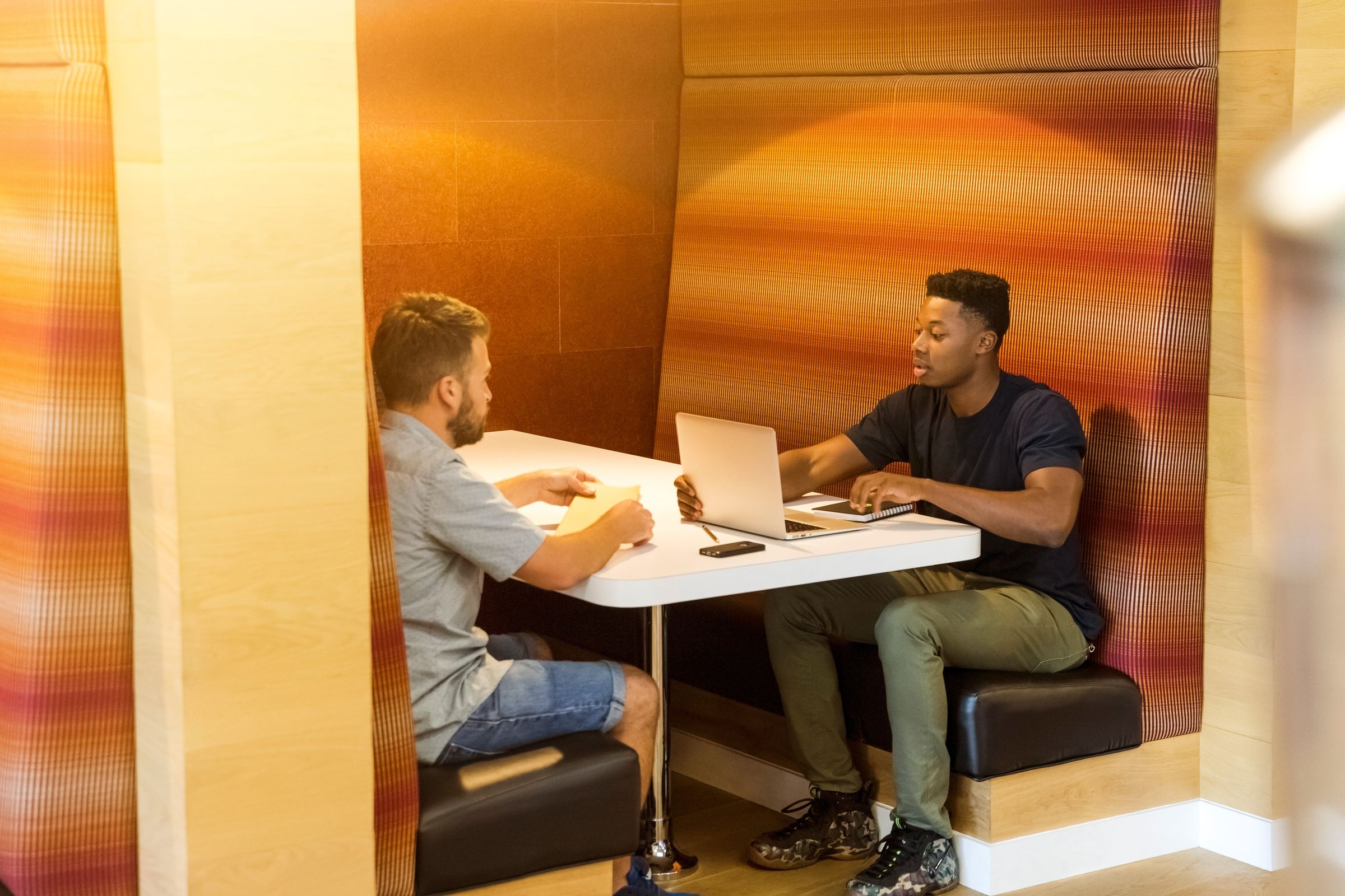 Two men working together at a cafe table