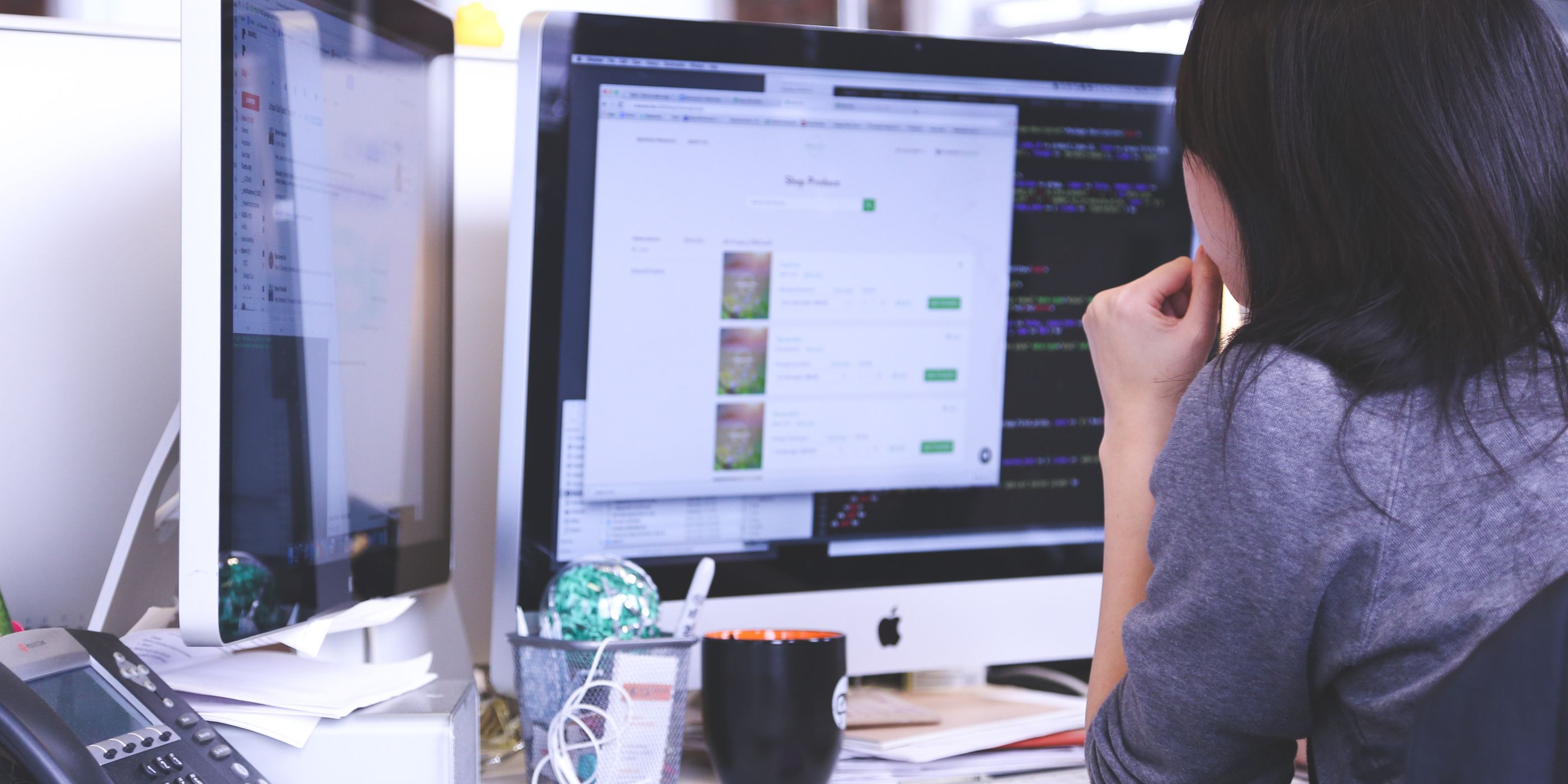 A woman working at a desktop screen