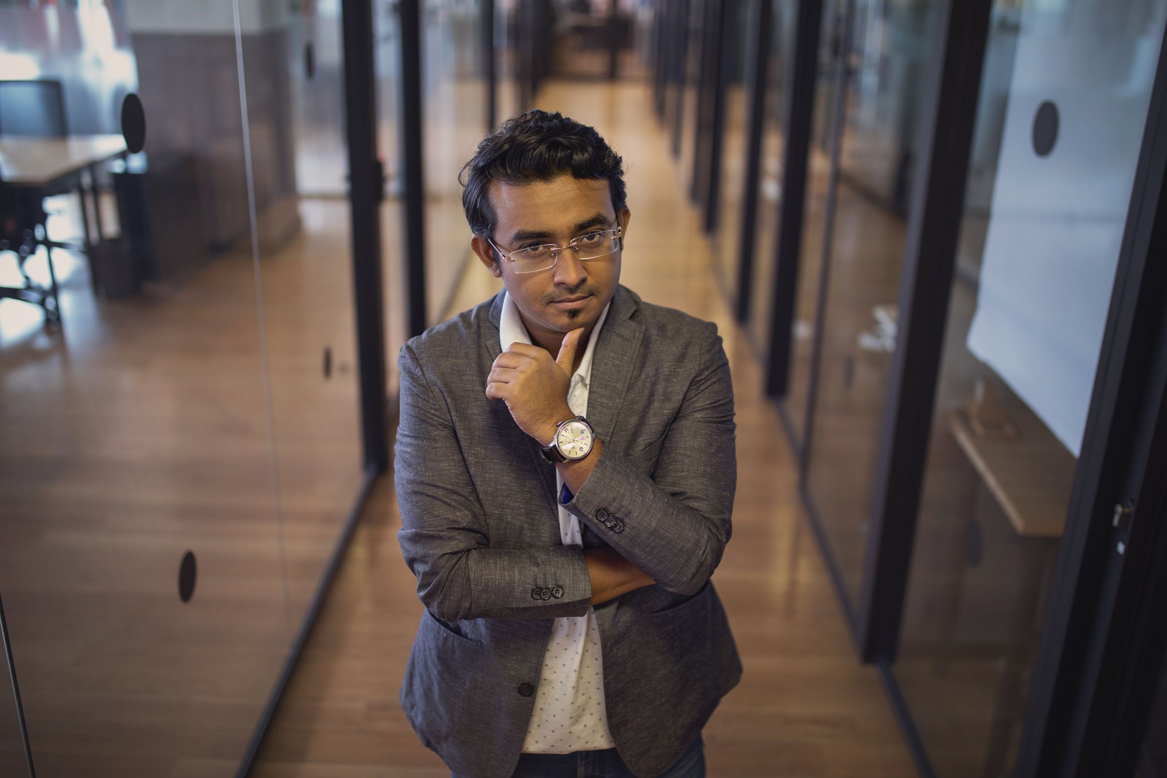 A man standing in an office corridor