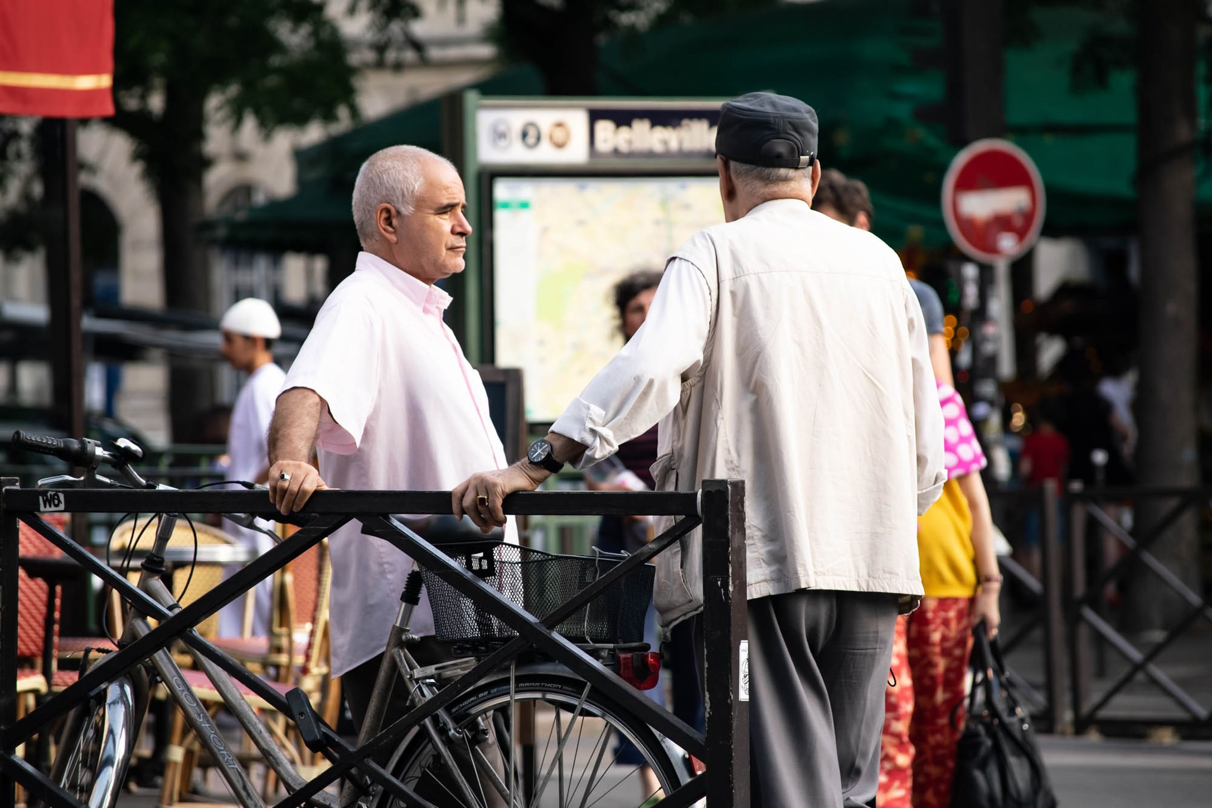 Two older men talking on a city street
