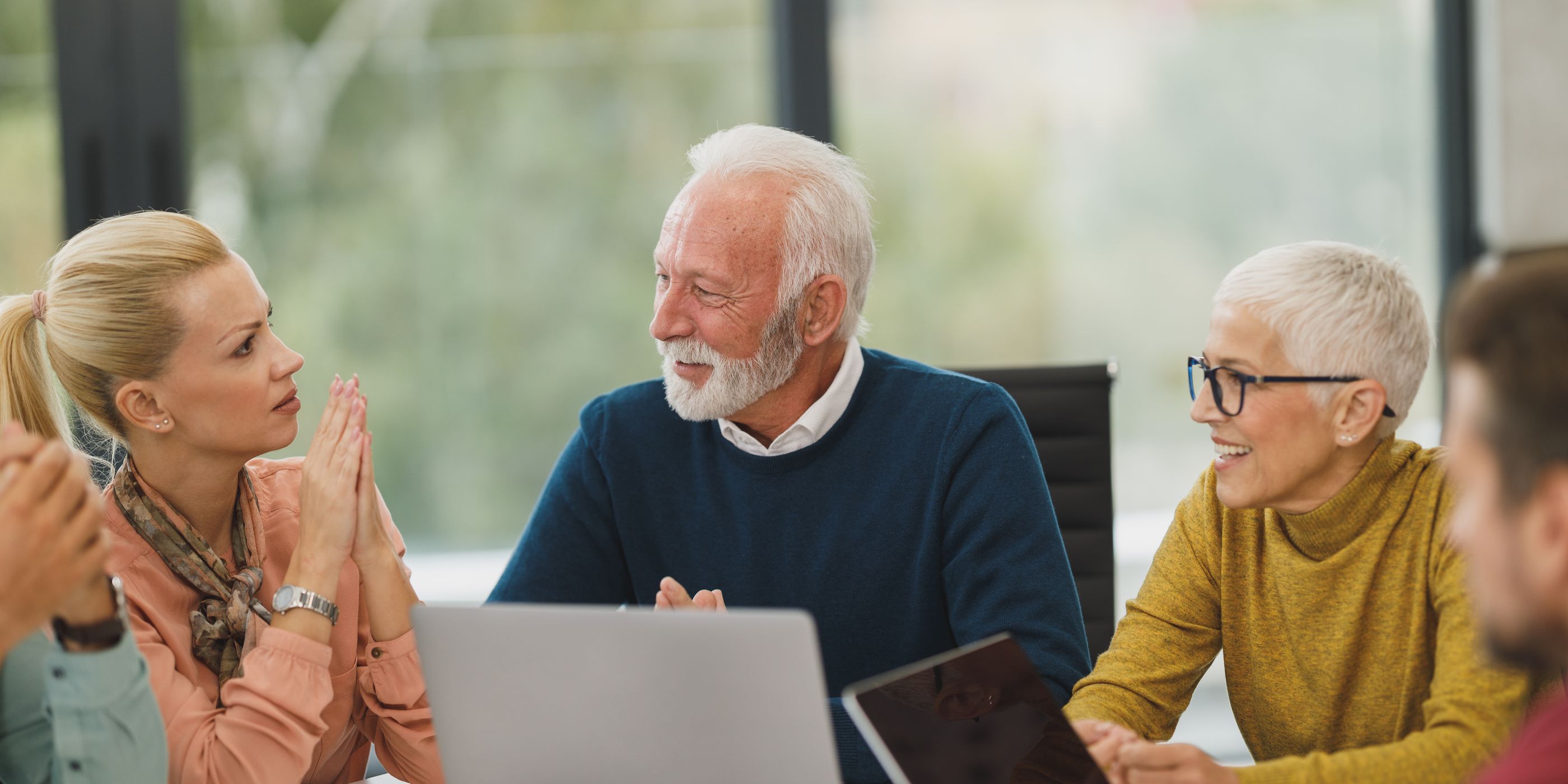 An older couple in discussion with an adviser
