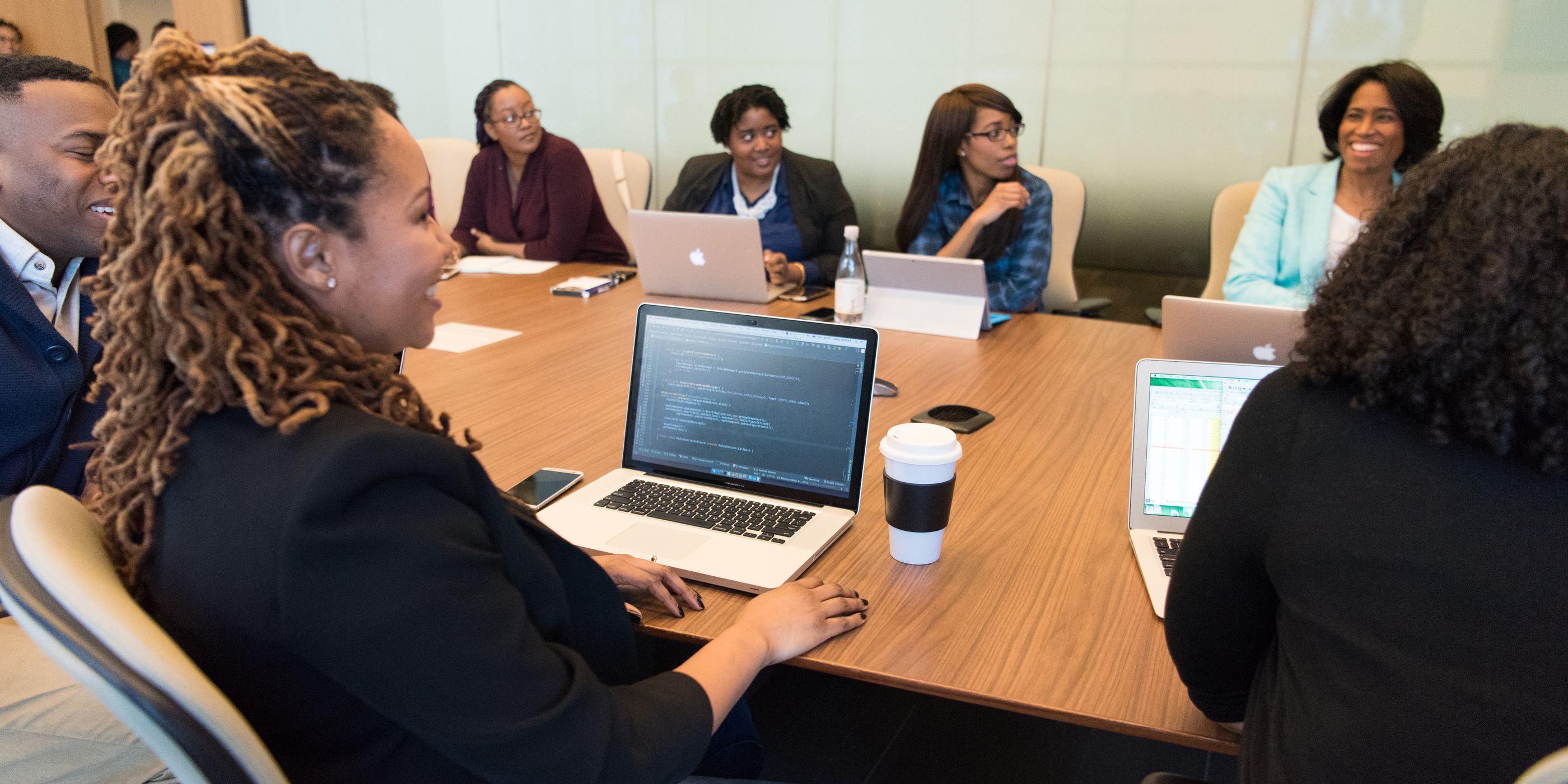 A team laughing around a meeting table